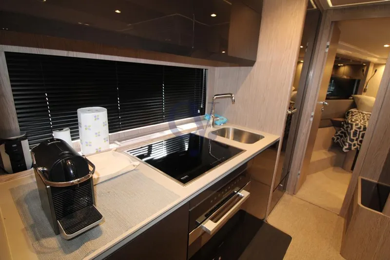  Yacht Photos Pics Modern kitchen interior of 2022 Azimut Atlantis 51 yacht with sleek appliances and stylish design.