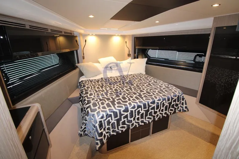  Yacht Photos Pics Luxurious bedroom interior of 2022 Azimut Atlantis 51 yacht with modern design and cozy bedding.