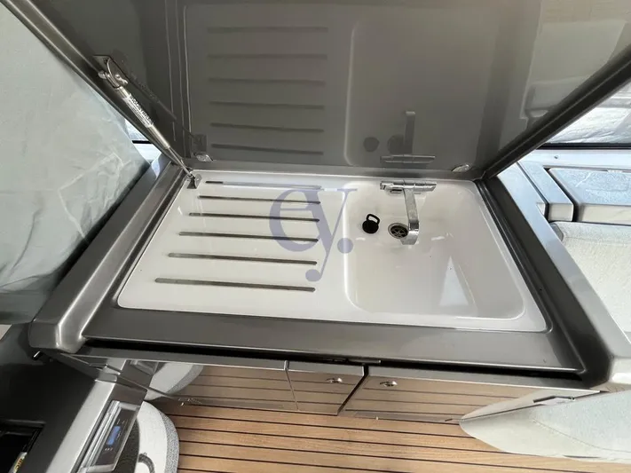  Yacht Photos Pics Modern sink on Azimut Atlantis 51 yacht, 2022 model, with sleek design and wooden flooring.