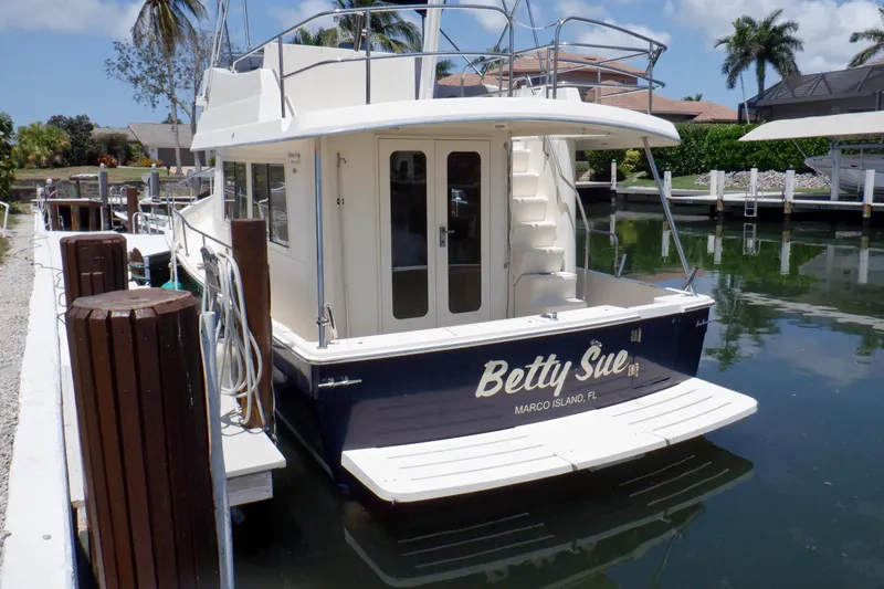 Betty Sue Yacht Photos Pics 2006 Mainship 34 Trawler docked, rear view, with "Betty Sue" name, Marco Island, Florida.