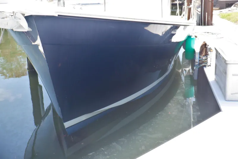 Betty Sue Yacht Photos Pics 2006 Mainship 34 Trawler docked, reflecting on calm water.