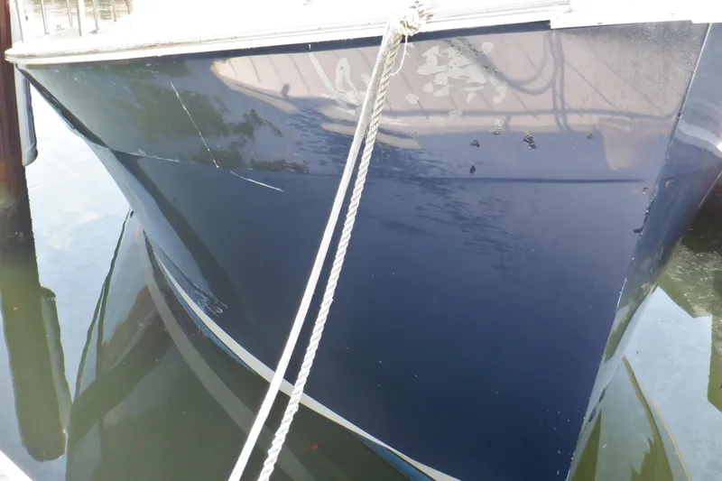 Betty Sue Yacht Photos Pics 2006 Mainship 34 Trawler, blue hull, docked with visible wear and rope.