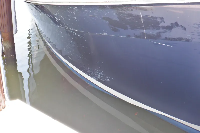 Betty Sue Yacht Photos Pics 2006 Mainship 34 Trawler hull with visible scratches docked in water.