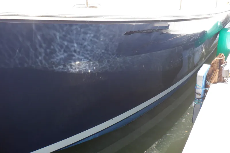 Betty Sue Yacht Photos Pics 2006 Mainship 34 Trawler hull with visible water reflections and dockside view.