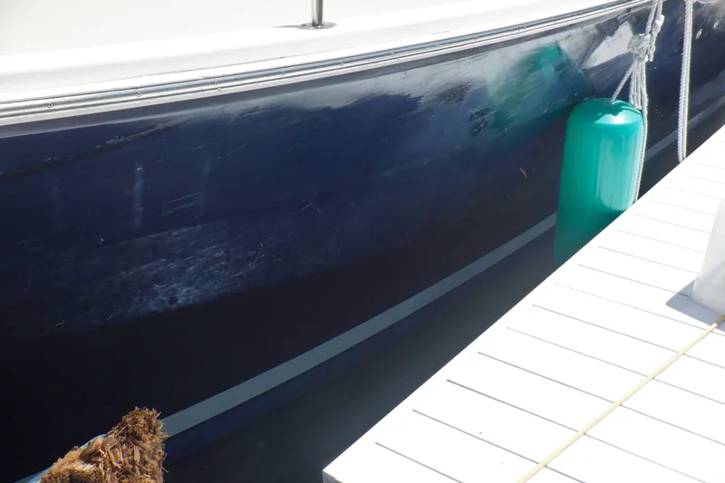 Betty Sue Yacht Photos Pics 2006 Mainship 34 Trawler docked with green fender and white deck.