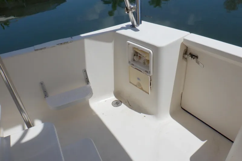 Betty Sue Yacht Photos Pics 2006 Mainship 34 Trawler deck area with storage compartment and water access.