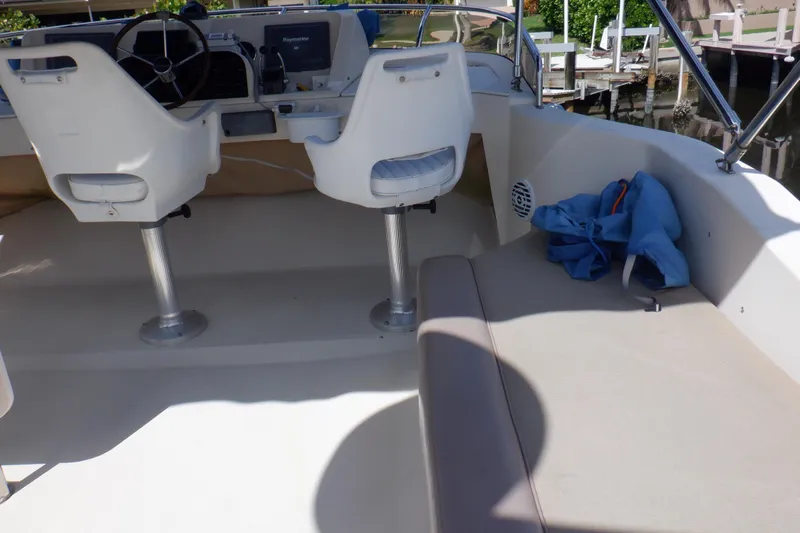 Betty Sue Yacht Photos Pics 2006 Mainship 34 Trawler cockpit with helm chairs and seating area.