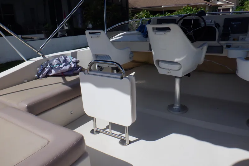 Betty Sue Yacht Photos Pics 2006 Mainship 34 Trawler interior with seating and steering wheel.