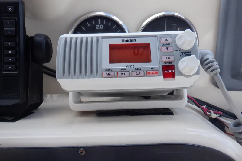 Betty Sue Yacht Photos Pics VHF radio on 2006 Mainship 34 Trawler dashboard, featuring Uniden UM385 model.