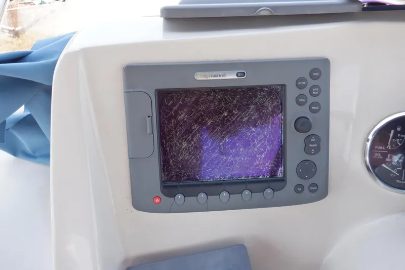 Betty Sue Yacht Photos Pics Cracked navigation display on 2006 Mainship 34 Trawler boat dashboard.