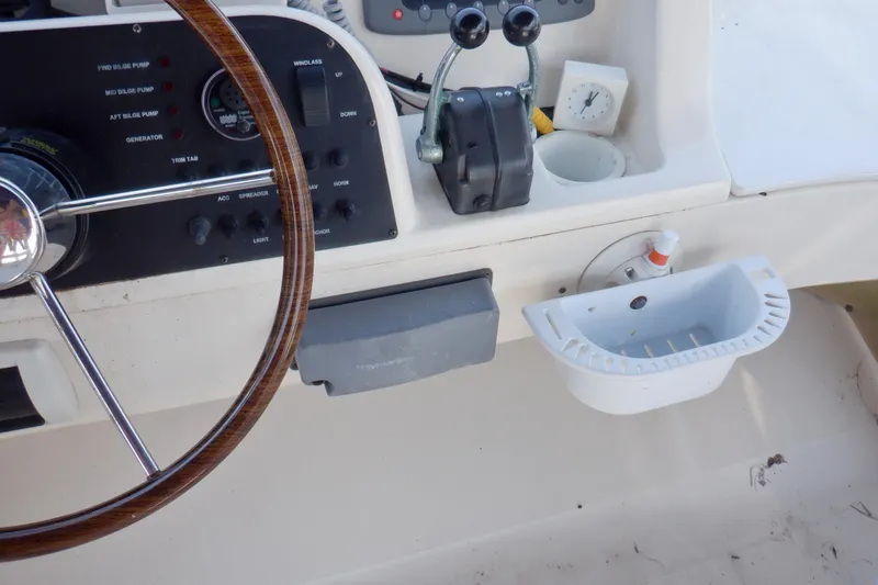 Betty Sue Yacht Photos Pics 2006 Mainship 34 Trawler helm with steering wheel and control panel.