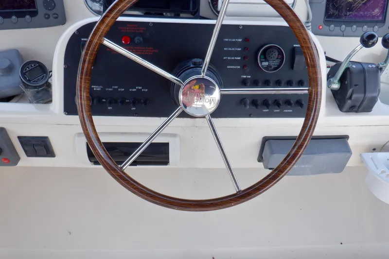 Betty Sue Yacht Photos Pics Steering wheel and controls of a 2006 Mainship 34 Trawler boat.