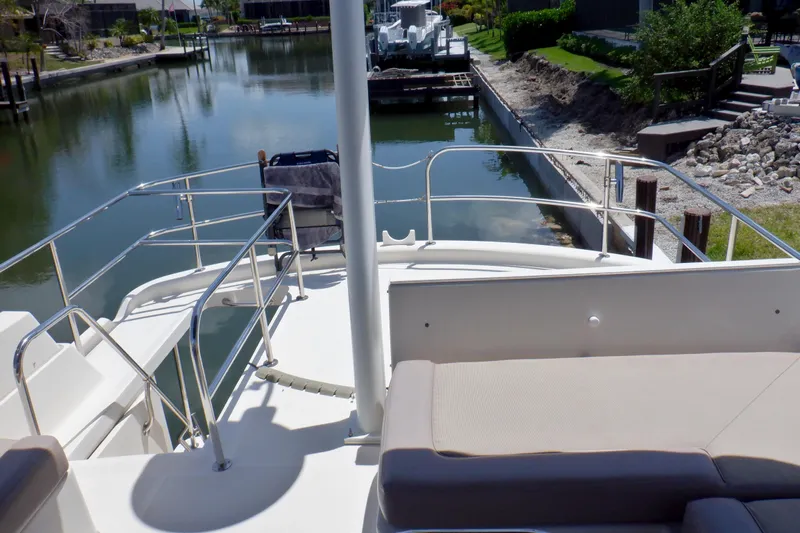 Betty Sue Yacht Photos Pics 2006 Mainship 34 Trawler deck overlooking calm canal and lush greenery.