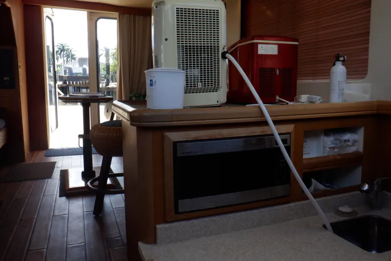 Betty Sue Yacht Photos Pics Interior of 2006 Mainship 34 Trawler with kitchen and dining area.