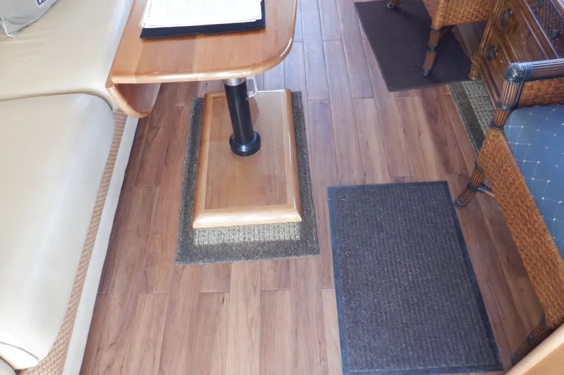 Betty Sue Yacht Photos Pics Interior of 2006 Mainship 34 Trawler with wooden flooring and cozy seating area.