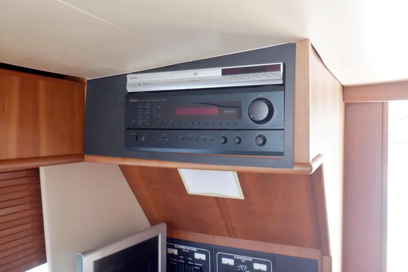 Betty Sue Yacht Photos Pics Audio system in 2006 Mainship 34 Trawler cabin, featuring a Denon stereo unit.