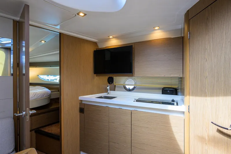  Yacht Photos Pics Luxurious interior of 2015 Beneteau 38 GT yacht with modern kitchen and cozy cabin.