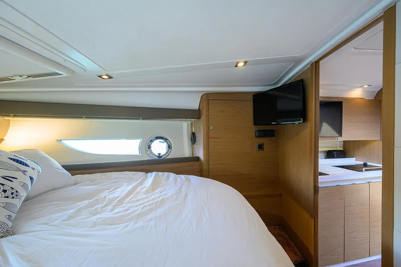  Yacht Photos Pics Luxurious interior of 2015 Beneteau 38 GT yacht with cozy bed and modern amenities.