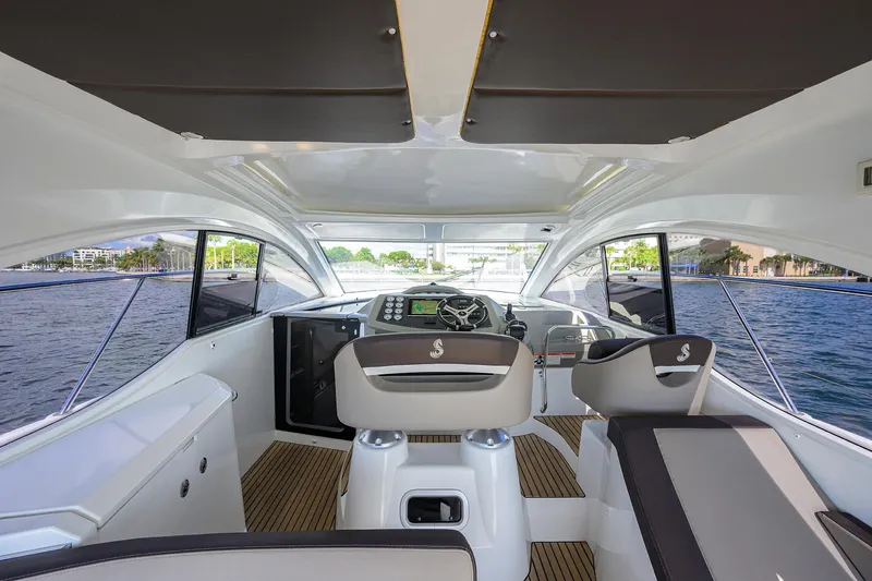  Yacht Photos Pics Interior view of 2015 Beneteau 38 GT yacht, featuring modern helm and seating.