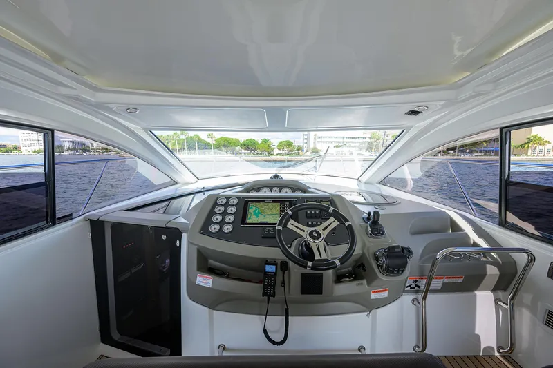  Yacht Photos Pics Interior cockpit of 2015 Beneteau 38 GT yacht with modern navigation equipment.