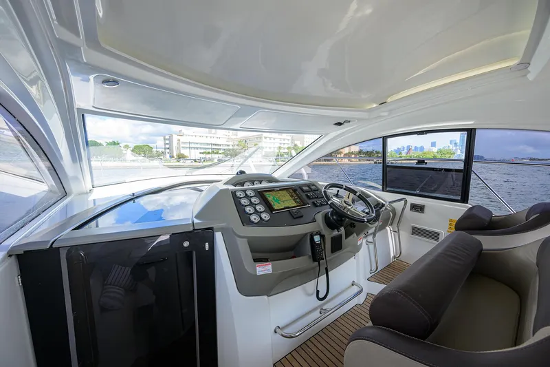  Yacht Photos Pics Interior view of 2015 Beneteau 38 GT yacht cockpit with modern controls and seating.