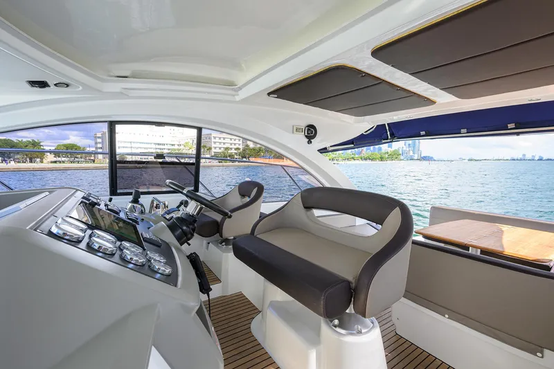  Yacht Photos Pics Interior view of 2015 Beneteau 38 GT yacht cockpit with modern seating and controls.