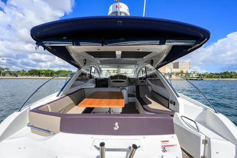  Yacht Photos Pics 2015 Beneteau 38 GT yacht with spacious deck and seating, docked by the waterfront.