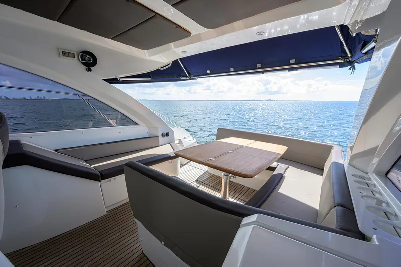  Yacht Photos Pics 2015 Beneteau 38 GT yacht interior with ocean view, featuring sleek seating and table.