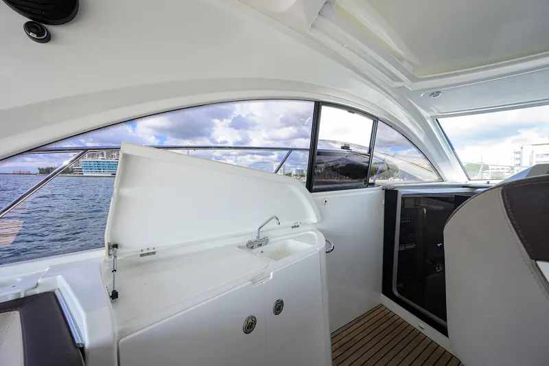  Yacht Photos Pics Interior view of 2015 Beneteau 38 GT yacht with open hatch and scenic water backdrop.