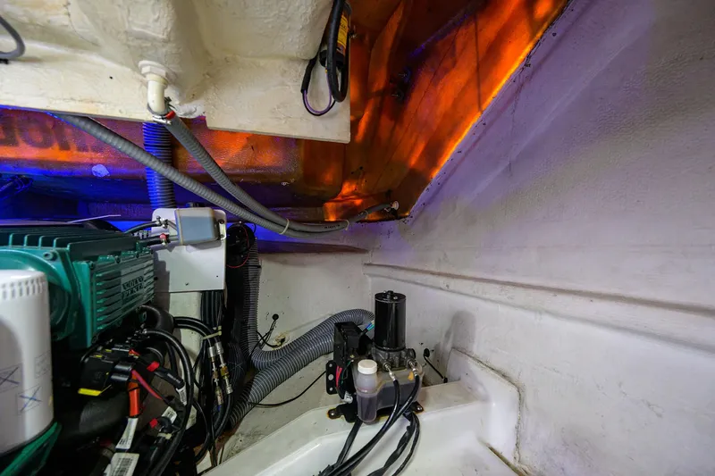  Yacht Photos Pics Engine room of 2015 Beneteau 38 GT yacht, showcasing mechanical components and wiring.