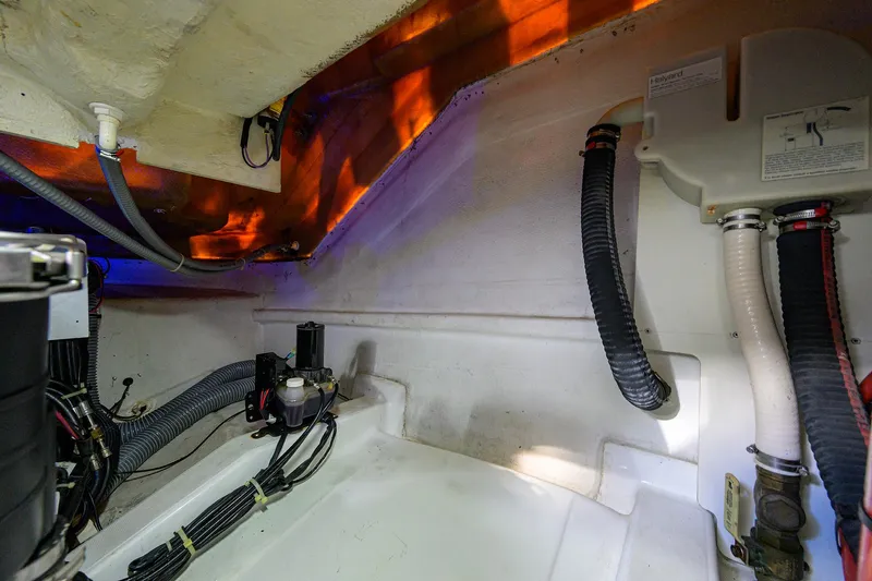  Yacht Photos Pics Engine compartment of 2015 Beneteau 38 GT boat, showcasing wiring and hoses.