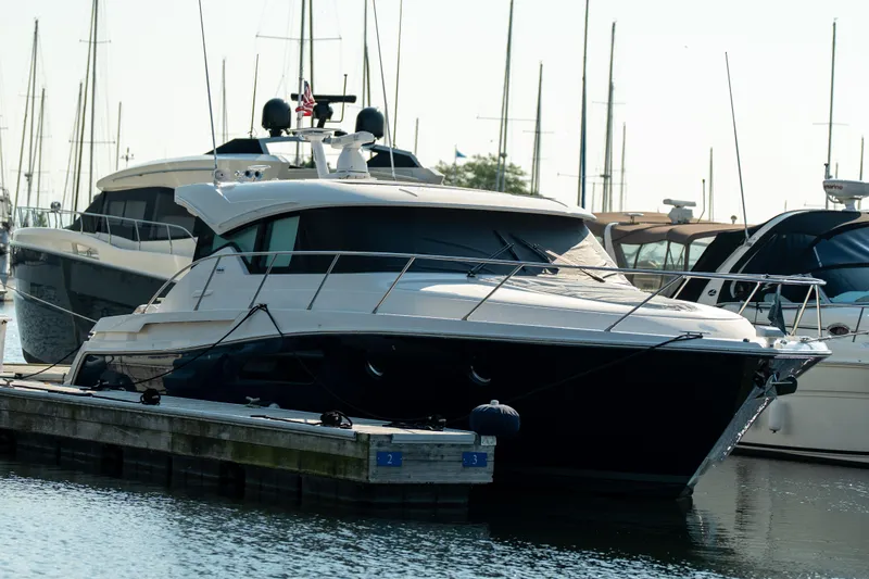 Escapade Yacht Photos Pics 2017 Tiara Yachts C44 Coupe docked at marina, surrounded by other boats.