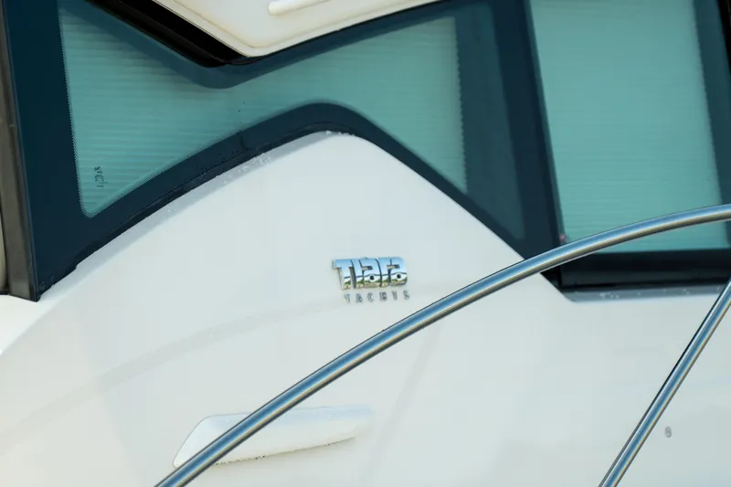 Escapade Yacht Photos Pics 2017 Tiara Yachts C44 Coupe, close-up of logo and window detail.