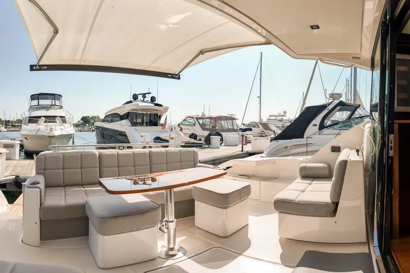 Escapade Yacht Photos Pics Luxurious 2017 Tiara Yachts C44 Coupe interior with elegant seating and marina view.
