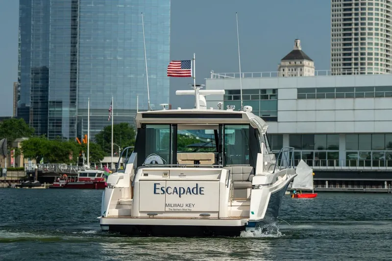 Escapade Yacht Photos Pics 2017 Tiara Yachts C44 Coupe "Escapade" cruising near city waterfront.