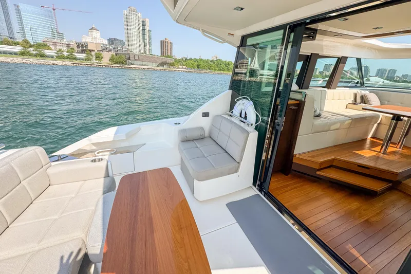 Escapade Yacht Photos Pics Luxurious 2017 Tiara Yachts C44 Coupe with elegant interior and waterfront city view.