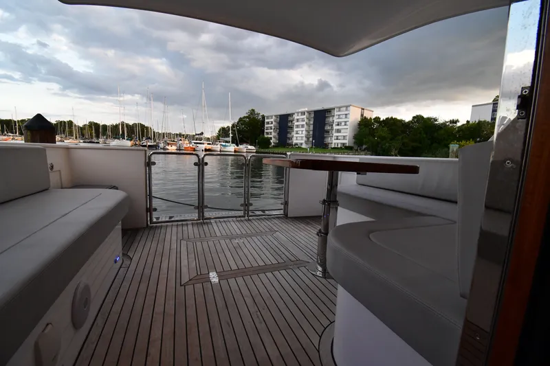 Promesa Yacht Photos Pics Luxurious 2021 Hylas M44 yacht deck with marina view and modern seating.