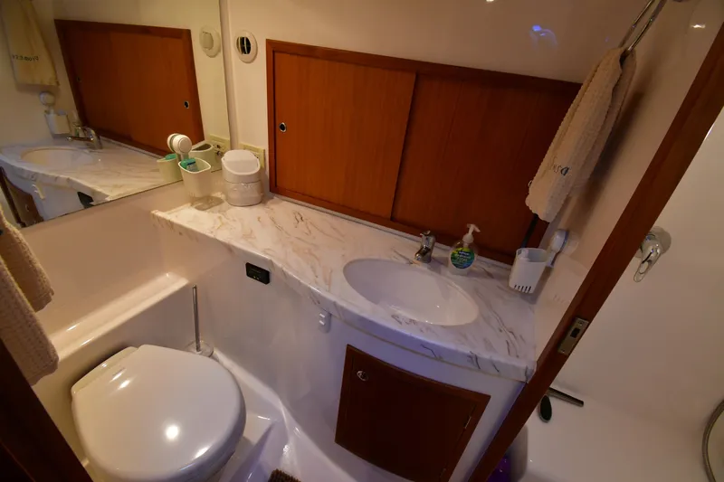 Promesa Yacht Photos Pics Luxurious bathroom in 2021 Hylas M44 yacht with marble countertop and wooden cabinetry.