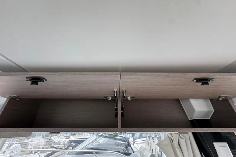  Yacht Photos Pics Open storage cabinet on 2026 Jeanneau NC 1095 boat interior.