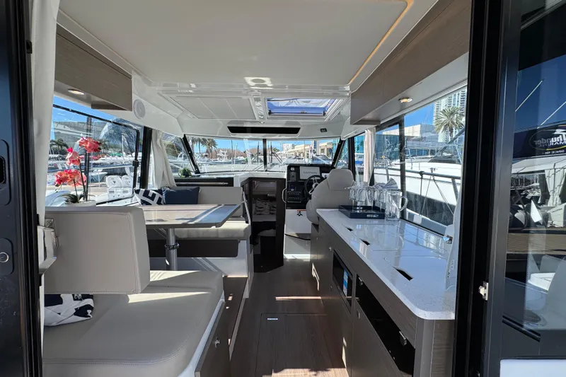  Yacht Photos Pics Interior of 2026 Jeanneau NC 1095 boat, featuring modern seating and sleek design.