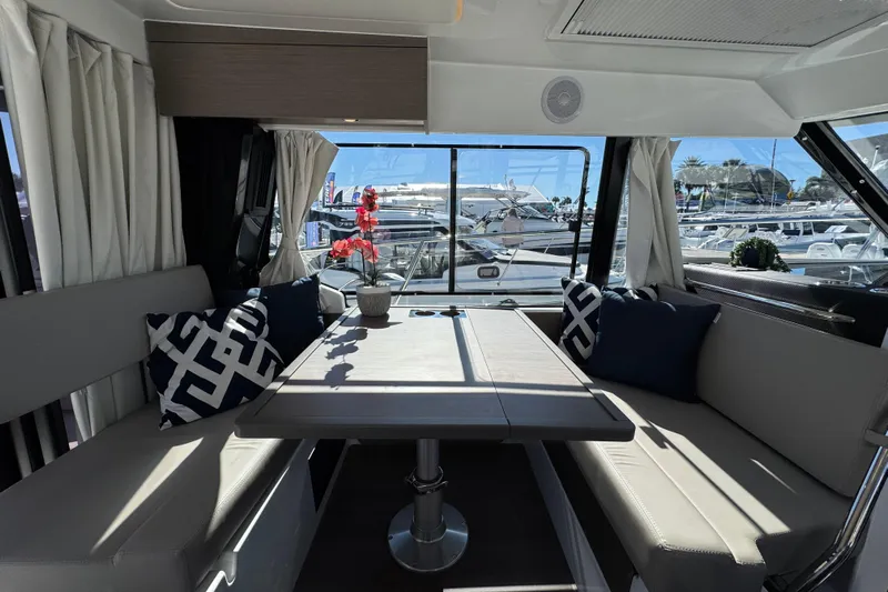  Yacht Photos Pics Interior of 2026 Jeanneau NC 1095 yacht with elegant seating and table.
