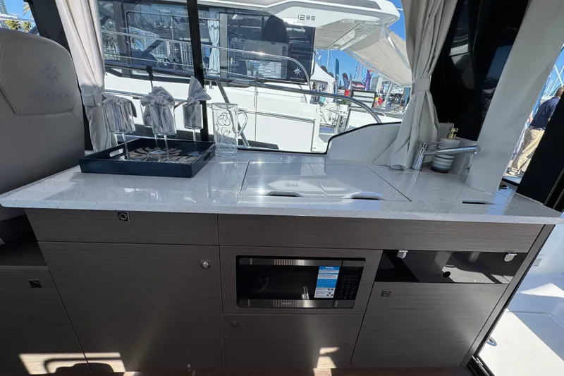  Yacht Photos Pics Modern kitchen area on 2026 Jeanneau NC 1095 yacht with sleek countertop and appliances.