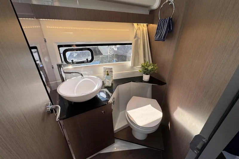  Yacht Photos Pics Modern bathroom interior of 2026 Jeanneau NC 1095 yacht, featuring sleek design and amenities.