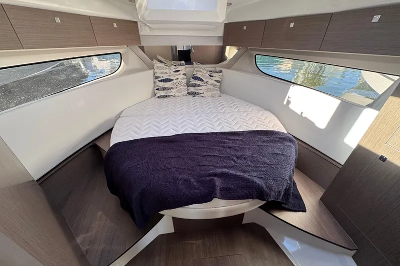  Yacht Photos Pics Interior of 2026 Jeanneau NC 1095 boat with cozy bed and modern design.