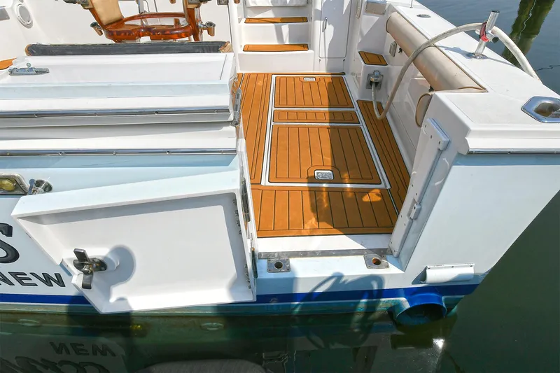  Yacht Photos Pics 1999 Cabo 45 Express boat deck with teak flooring and open storage compartments.