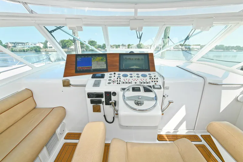  Yacht Photos Pics Interior view of 1999 Cabo 45 Express yacht helm with navigation equipment.
