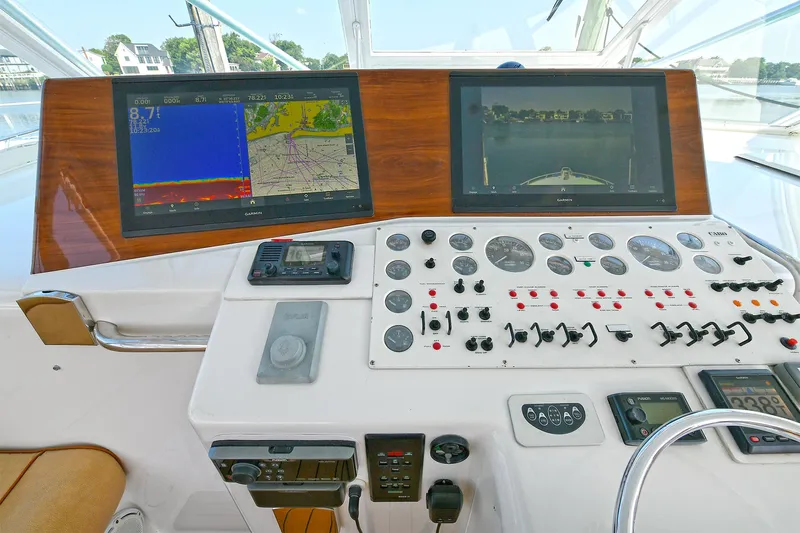  Yacht Photos Pics Control panel of a 1999 Cabo 45 Express boat with navigation screens and gauges.