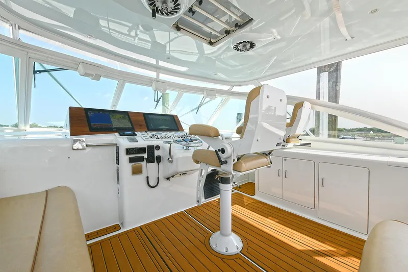  Yacht Photos Pics 1999 Cabo 45 Express yacht helm with modern controls and seating.