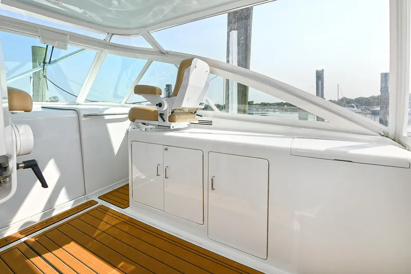  Yacht Photos Pics 1999 Cabo 45 Express boat interior with white cabinetry and wooden flooring.