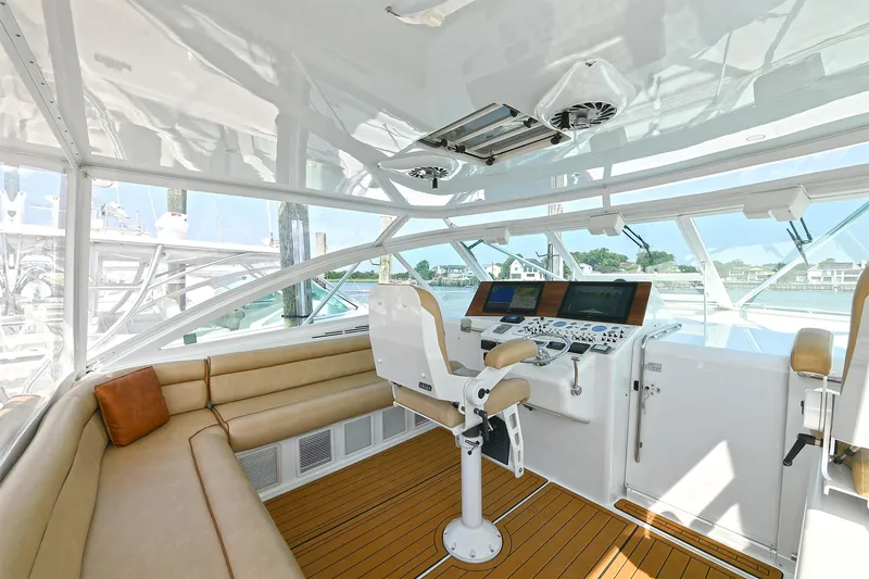  Yacht Photos Pics Luxurious 1999 Cabo 45 Express yacht interior with helm and seating area.